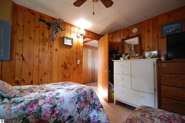 4038 Ogemaw Shores Dr, West Branch, MI 48661 - carpeted bedroom featuring wood walls and a ceiling fan
