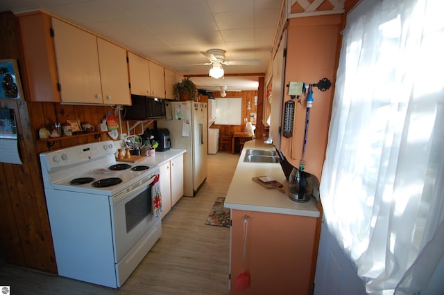 4038 Ogemaw Shores Dr, West Branch, MI 48661 - kitchen with white appliances, light countertops, a ceiling fan, and light wood-style floors