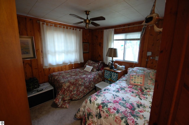 4038 Ogemaw Shores Dr, West Branch, MI 48661 - bedroom featuring wooden walls, carpet flooring, and ceiling fan
