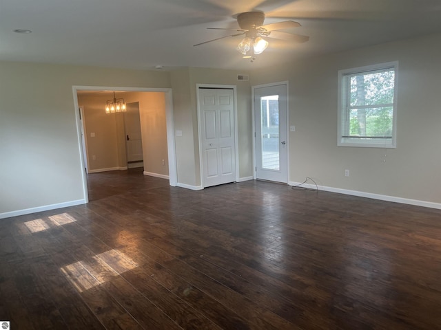 2507 N Lincoln Rd, Rosebush, MI 48878 - empty room featuring a chandelier, dark wood-style flooring, and ceiling fan
