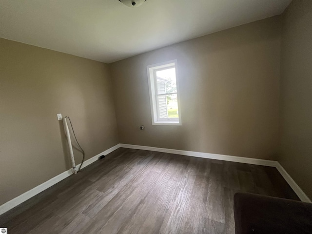 2507 N Lincoln Rd, Rosebush, MI 48878 - unfurnished room featuring dark wood finished floors and baseboards
