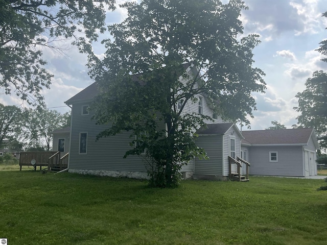 2507 N Lincoln Rd, Rosebush, MI 48878 - view of side of home with entry steps, a wooden deck, a yard, and an outdoor structure