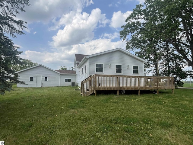2507 N Lincoln Rd, Rosebush, MI 48878 - back of property with a lawn and a wooden deck