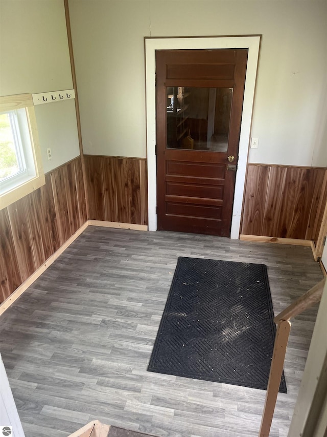 2507 N Lincoln Rd, Rosebush, MI 48878 - empty room featuring a wainscoted wall, wooden walls, and wood finished floors
