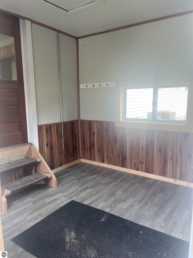 2507 N Lincoln Rd, Rosebush, MI 48878 - unfurnished room with wood finished floors, a wainscoted wall, and wooden walls
