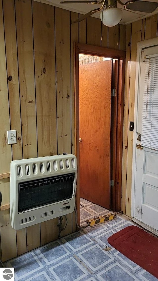 1947 NE Anita Rd, Kalkaska, MI 49646 - detailed view of heating unit, a ceiling fan, and wood walls