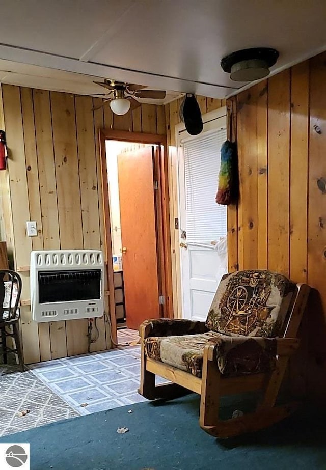 1947 NE Anita Rd, Kalkaska, MI 49646 - sitting room featuring heating unit, a ceiling fan, and wooden walls
