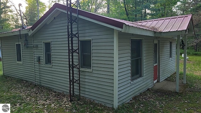 1947 NE Anita Rd, Kalkaska, MI 49646 - view of side of home with a metal roof