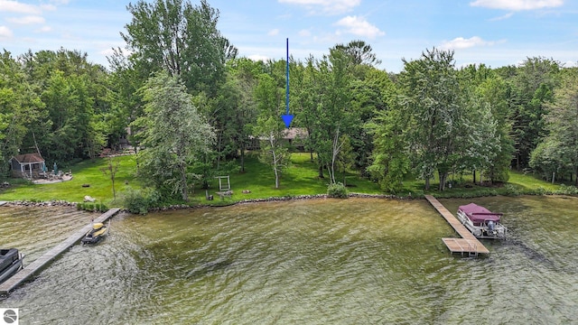 7786 N Shore Ct, Grawn, MI 49637 - dock featuring a water view and a lawn