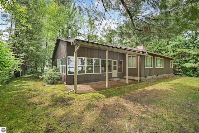 7786 N Shore Ct, Grawn, MI 49637 - back of house with crawl space, a yard, and a patio