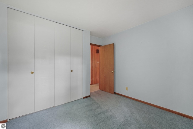 7786 N Shore Ct, Grawn, MI 49637 - unfurnished bedroom featuring carpet and a closet