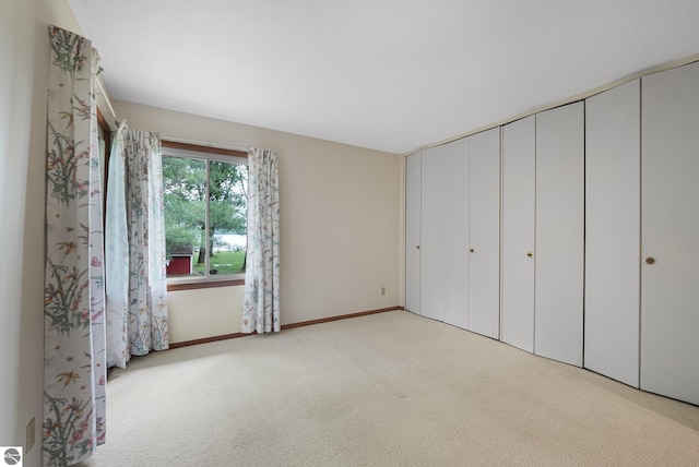 7786 N Shore Ct, Grawn, MI 49637 - unfurnished bedroom with carpet and a closet