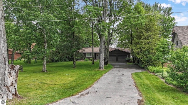 7786 N Shore Ct, Grawn, MI 49637 - view of front of property featuring a front lawn and a garage