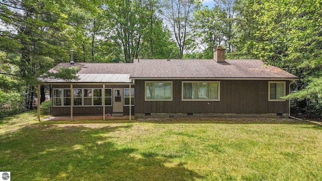 7786 N Shore Ct, Grawn, MI 49637 - rear view of property with crawl space, a chimney, roof with shingles, and a lawn