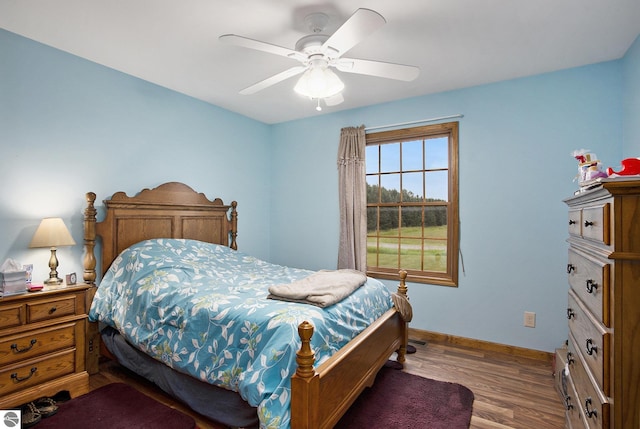 1520 Kuehn Rd, Sterling, MI 48659 - bedroom featuring wood finished floors and a ceiling fan