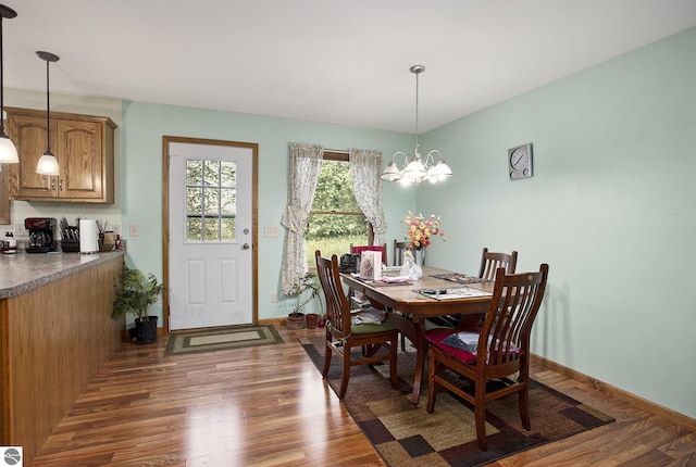 1520 Kuehn Rd, Sterling, MI 48659 - dining area featuring dark wood-type flooring and a chandelier