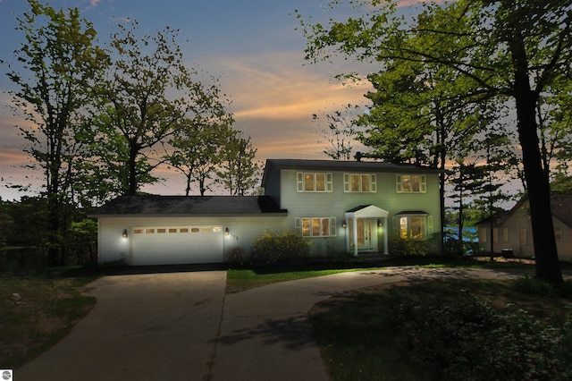 398 High View Rd, Traverse City, MI 49696 - colonial home with concrete driveway and a garage