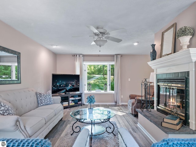 398 High View Rd, Traverse City, MI 49696 - living area with a fireplace, ceiling fan, and wood finished floors