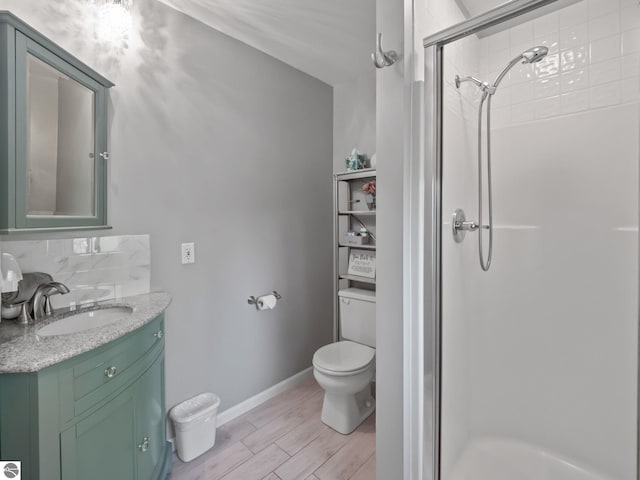398 High View Rd, Traverse City, MI 49696 - bathroom featuring a stall shower, vanity, decorative backsplash, and wood finished floors