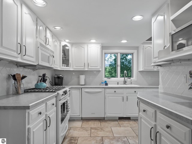 398 High View Rd, Traverse City, MI 49696 - kitchen with white appliances, light countertops, white cabinetry, decorative backsplash, and recessed lighting