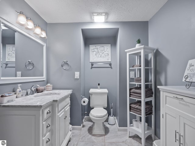 398 High View Rd, Traverse City, MI 49696 - bathroom featuring vanity, a textured ceiling, and marble look tile flooring