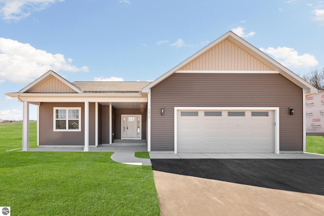 1572 Oban Way, Traverse City, MI 49696 - view of front of house featuring board and batten siding, a front yard, asphalt driveway, an attached garage, and a porch