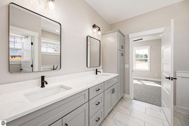 1572 Oban Way, Traverse City, MI 49696 - full bath featuring double vanity, healthy amount of natural light, and marble finish flooring