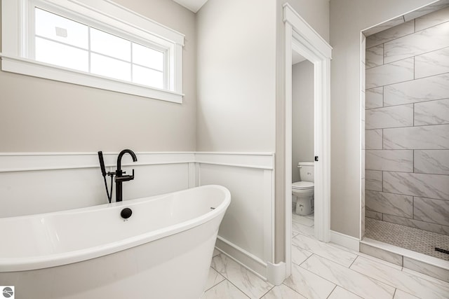 1572 Oban Way, Traverse City, MI 49696 - bathroom with marble look tiles, a soaking tub, and tiled shower