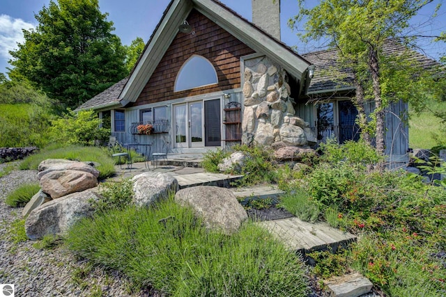 10702 E Hill Top Rd, Suttons Bay, MI 49682 - view of front of property featuring a chimney, stone siding, and a patio