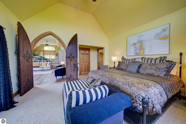 10702 E Hill Top Rd, Suttons Bay, MI 49682 - bedroom featuring carpet, arched walkways, and high vaulted ceiling