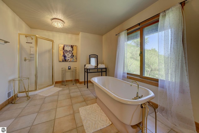 10702 E Hill Top Rd, Suttons Bay, MI 49682 - bathroom featuring a shower stall, a soaking tub, and tile patterned floors