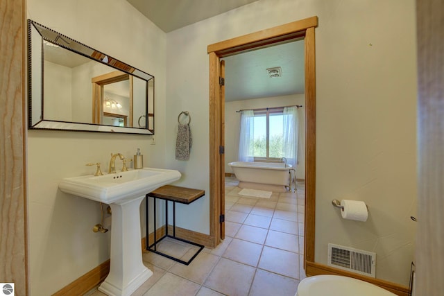10702 E Hill Top Rd, Suttons Bay, MI 49682 - full bathroom with a soaking tub and tile patterned floors