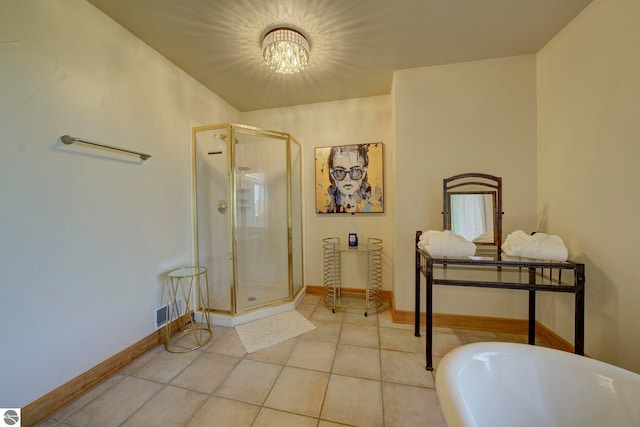 10702 E Hill Top Rd, Suttons Bay, MI 49682 - full bathroom with a shower stall, a freestanding tub, a chandelier, and tile patterned floors