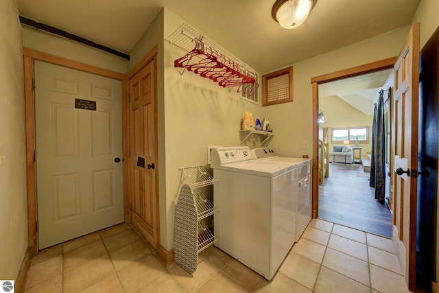 10702 E Hill Top Rd, Suttons Bay, MI 49682 - laundry room with washing machine and clothes dryer and light tile patterned floors