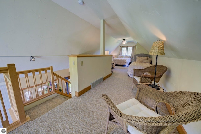 10702 E Hill Top Rd, Suttons Bay, MI 49682 - living area with carpet, lofted ceiling, ceiling fan, and an upstairs landing