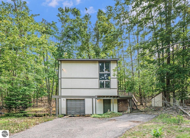 6740 Pheasant Run, Gaylord, MI 49735 - view of front of home featuring stairs, an attached garage, and asphalt driveway