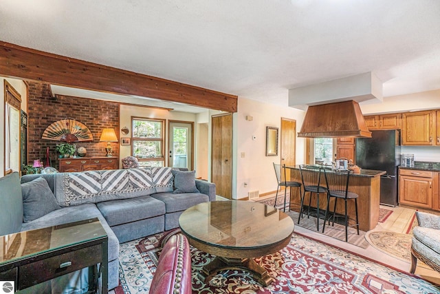 6740 Pheasant Run, Gaylord, MI 49735 - living area with light wood-style floors and beamed ceiling