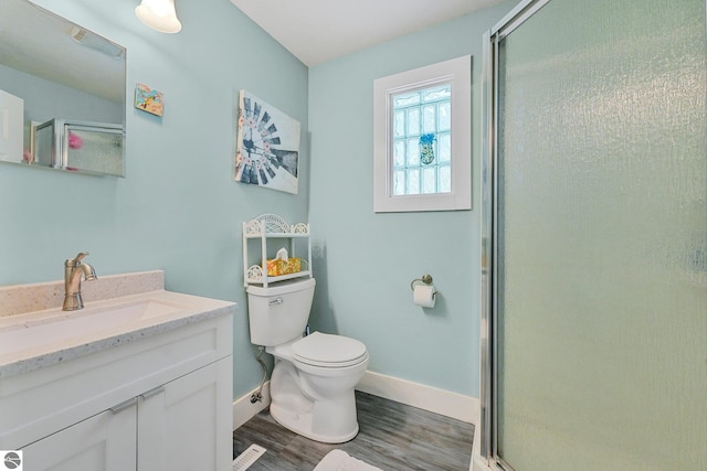 1029 E Front St, Traverse City, MI 49686 - full bathroom featuring wood finished floors, vanity, and a stall shower