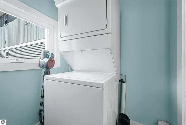 1029 E Front St, Traverse City, MI 49686 - laundry area with stacked washer / drying machine and baseboards