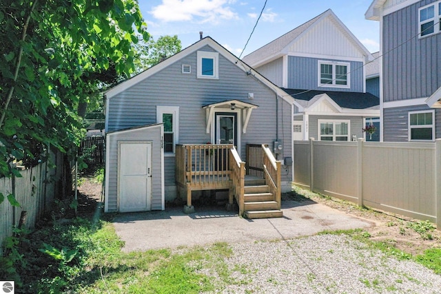 1029 E Front St, Traverse City, MI 49686 - back of property featuring a fenced backyard, a shed, and board and batten siding