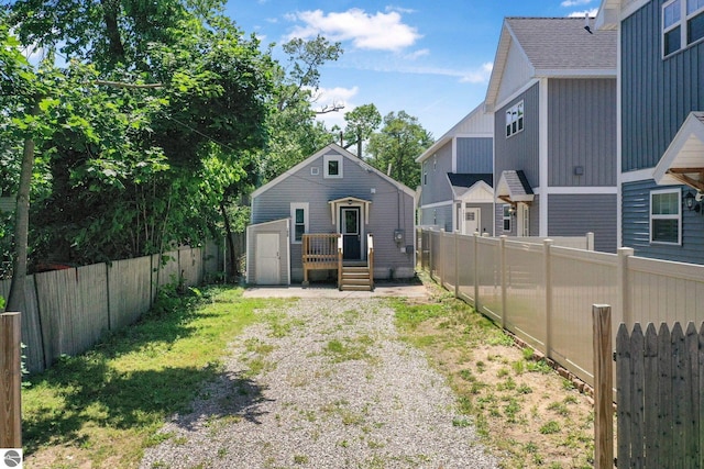 1029 E Front St, Traverse City, MI 49686 - back of house featuring a fenced backyard and an outdoor structure