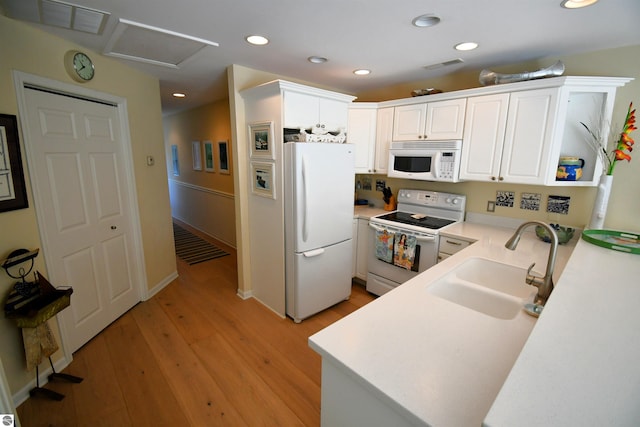 13354 Stover Rd Unit 6, Charlevoix, MI 49720 - kitchen featuring white appliances, light countertops, white cabinetry, light wood-type flooring, and recessed lighting