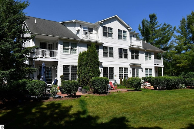 13354 Stover Rd Unit 6, Charlevoix, MI 49720 - back of property with a balcony and a lawn
