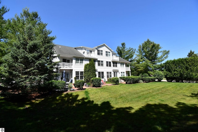 13354 Stover Rd Unit 6, Charlevoix, MI 49720 - rear view of property featuring a balcony and a yard