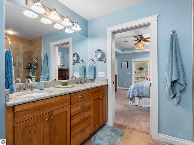 10355 Fencepost Ln, Traverse City, MI 49685 - ensuite bathroom with double vanity, tile patterned flooring, ceiling fan, and a tile shower