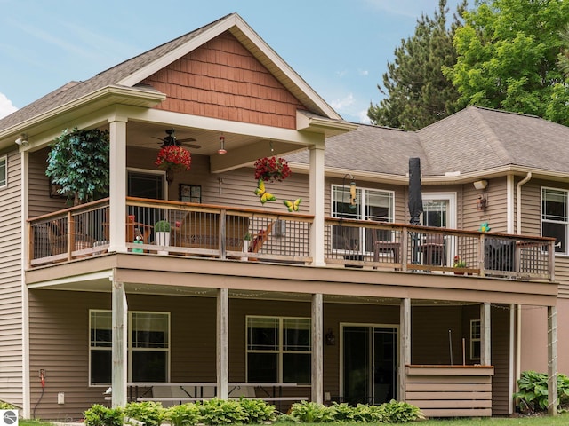 10355 Fencepost Ln, Traverse City, MI 49685 - back of property with a ceiling fan, roof with shingles, and a deck