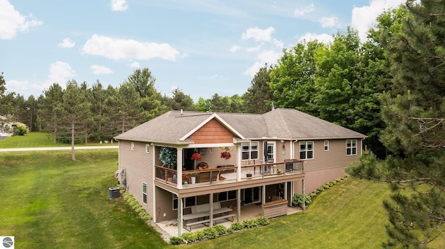 10355 Fencepost Ln, Traverse City, MI 49685 - back of property featuring a wooden deck, a lawn, and a patio