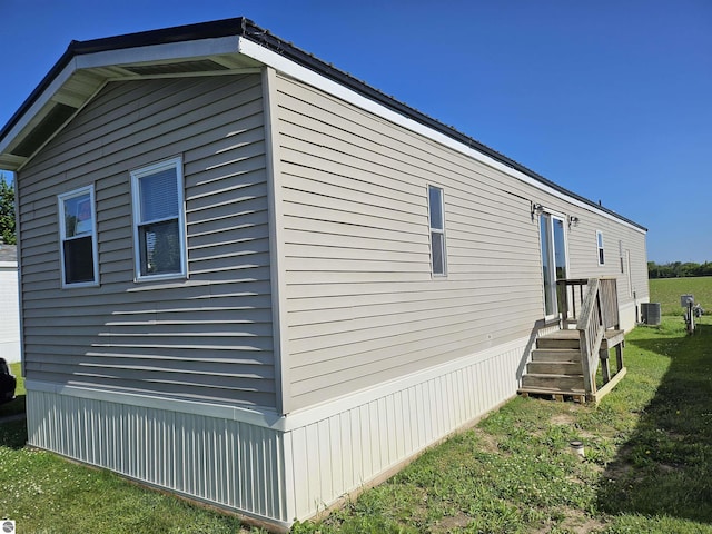 4151 E Jordan Rd Lot 51, Mount Pleasant, MI 48858 - view of home's exterior with a cooling unit and a yard