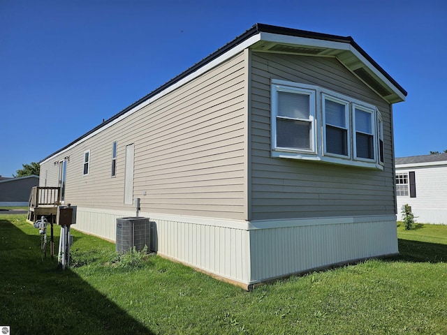 4151 E Jordan Rd Lot 51, Mount Pleasant, MI 48858 - view of home's exterior featuring a yard and a central AC unit