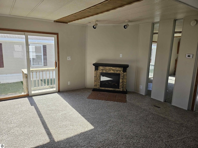 4151 E Jordan Rd Lot 51, Mount Pleasant, MI 48858 - unfurnished living room with carpet flooring and a stone fireplace